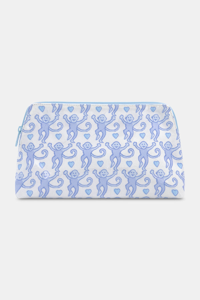 The Lovely Monkey Makeup Bag by Roller Rabbit is a white cotton canvas bag with a zippered top, decorated with light blue smiling cartoon monkeys and hearts—ideal as a cute travel or makeup bag.