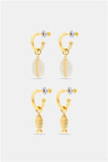 Roller Rabbit’s Marina Earrings Set includes two gold hoop pairs: one with white cowrie shell charms, the other with gold fish-shaped charms. Part of our oceanic jewelry collection, both come with clear earring backs.