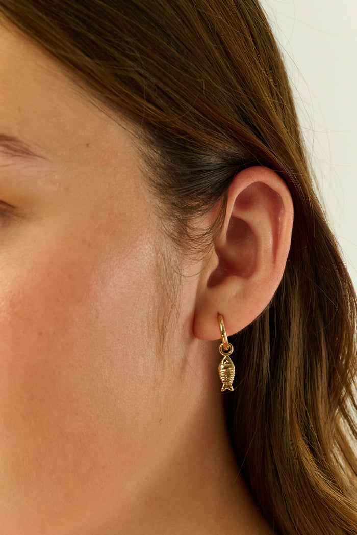 Roller Rabbit’s Marina Earrings Set includes two gold hoop pairs: one with white cowrie shell charms, the other with gold fish-shaped charms. Part of our oceanic jewelry collection, both come with clear earring backs.