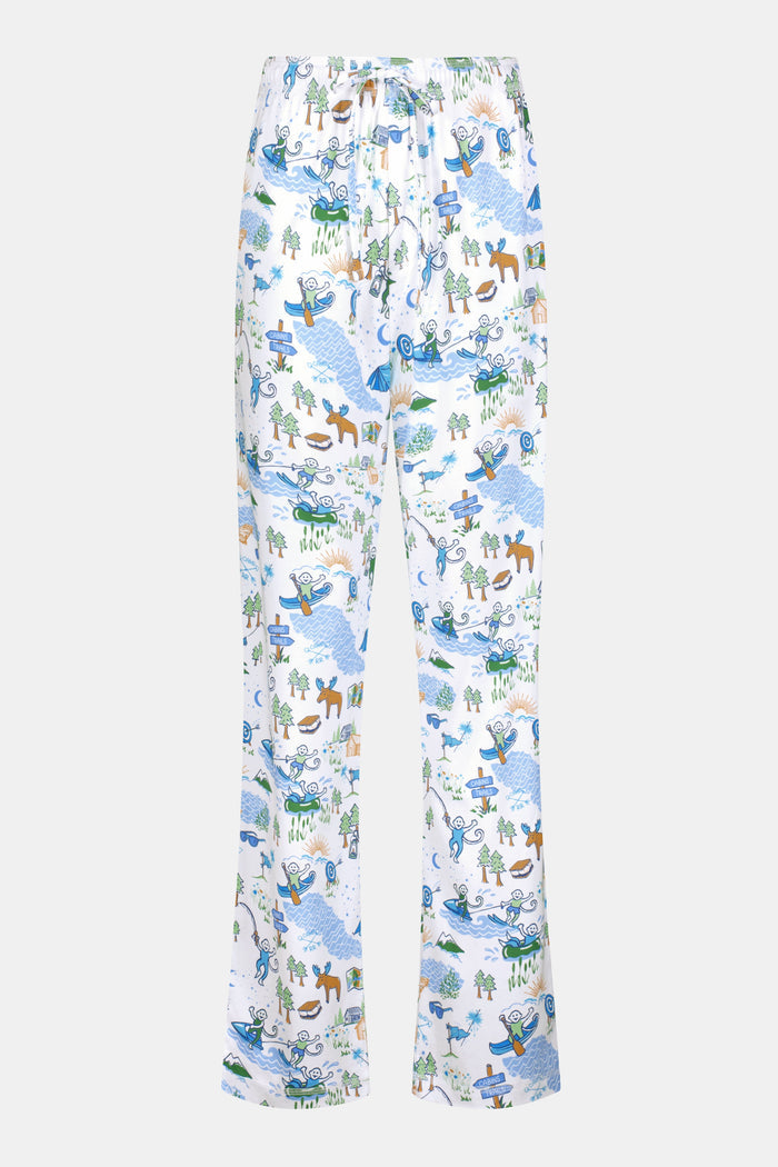 A person wears the Roller Rabbit Mens Camp RR Simon Pant, featuring a colorful animal and nature print, with hands in pockets and a plain white shirt. The barefoot individual stands against a white background.