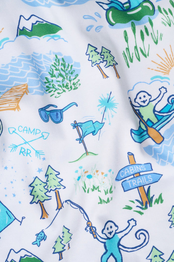 A person wears the Roller Rabbit Mens Camp RR Simon Pant, featuring a colorful animal and nature print, with hands in pockets and a plain white shirt. The barefoot individual stands against a white background.