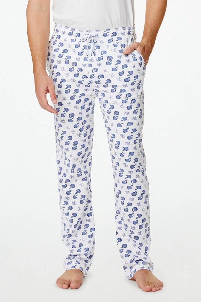 A person stands barefoot against a plain background, one hand in their pocket, wearing Roller Rabbit's Mens Moby Simon Pant—crafted from soft Pima cotton and featuring a blue paisley pattern.