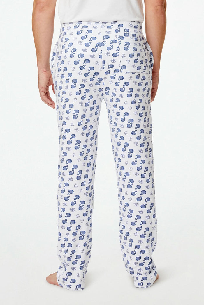 A person stands barefoot against a plain background, one hand in their pocket, wearing Roller Rabbit's Mens Moby Simon Pant—crafted from soft Pima cotton and featuring a blue paisley pattern.