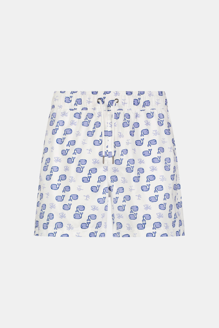 A person wearing the Roller Rabbit Mens Moby Swim Trunk—made from quick-dry polyester with a mesh-lined brief and a blue boxing glove pattern—stands barefoot against a white background.