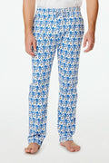 A person stands barefoot against a plain white background, showing only the lower half of their body while wearing Roller Rabbit Mens Monkey Simon Pant pajama pants.