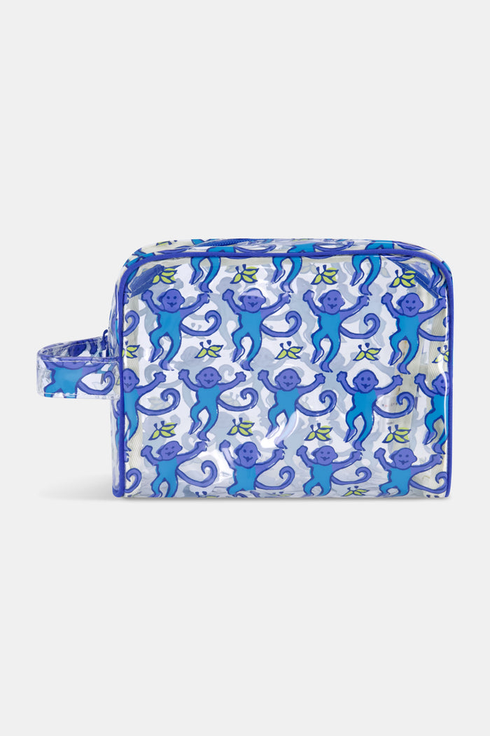 The Roller Rabbit Monkey Beach Pouch is a clear PVC bag with blue trim, decorated with cheerful blue cartoon monkeys—some holding bananas. Water-resistant and practical, it features a left-side handle for easy carrying.