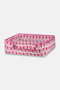 The Roller Rabbit Monkey Dog Bed features a vibrant pink, red, and green monkey print on white, raised sides, a lowered front for easy access, and is machine-washable for your pet's comfort and convenience.