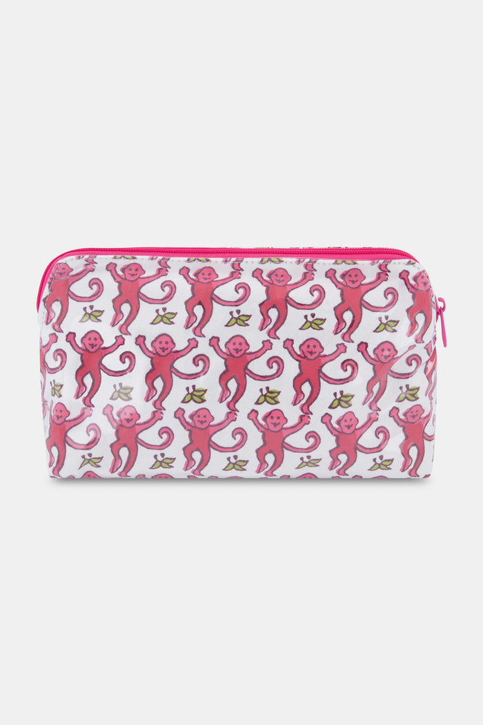 The Monkey Makeup Bag by Roller Rabbit is a white cotton canvas cosmetic pouch with a pink zipper, decorated with smiling pink monkeys and yellow bananas—perfect for travel.