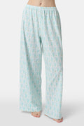 Wearing Roller Rabbit’s Monkey Monroe Pant in light blue and white heart-print cotton modal, the barefoot person stands against a white background, with only their lower torso and legs visible.