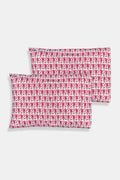 Two stacked pillows are covered with Roller Rabbit’s Monkey Pillowcase Set, featuring a playful pink monkey print with leaves. The whimsical pattern repeats across the entire surface, creating a charming and cheerful bedding look.