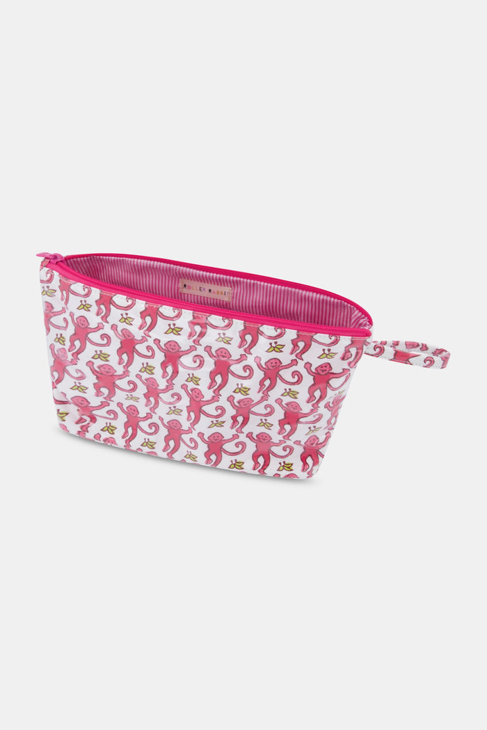 The Roller Rabbit Monkey Toiletry Case is a white, water-resistant zippered pouch with a handle, featuring a repeating print of crowned pink monkeys—perfect for organizing your travel essentials.