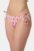 A person wears Roller Rabbit's Monkey/Hearts Serena Bikini Bottom, shown from mid-torso to upper thigh against a white background. These reversible bikini bottoms provide UPF 50+ sun protection.