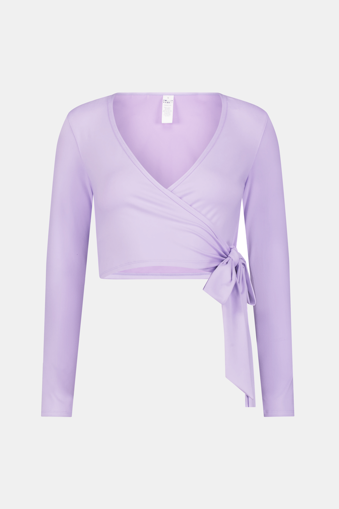 A woman wears the Roller Rabbit Morgan Wrap Top in lavender over a matching blue abstract sports bra, paired with high-waisted leggings in the same print. The photo is cropped from shoulders to waist.