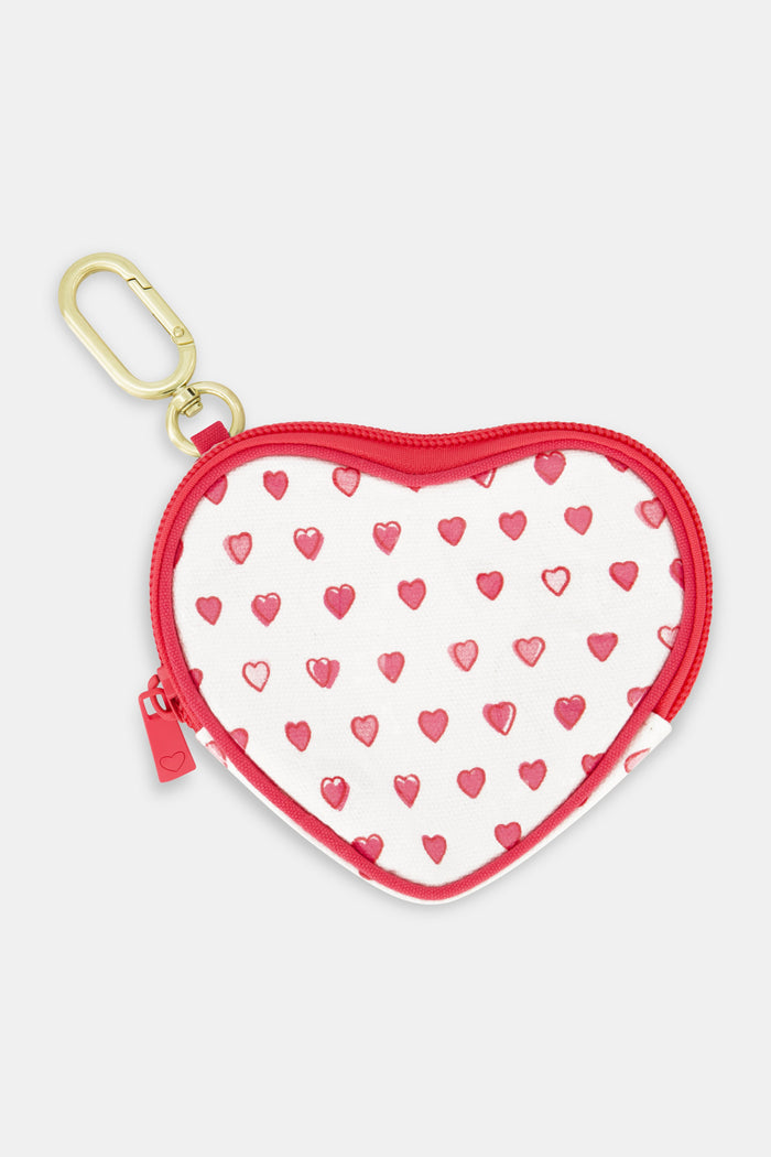 The Roller Rabbit Pop Hearts Heart Coin Pouch features a heart-shaped cotton canvas design with small red hearts on a white background, plus a red zipper and gold keychain clip.