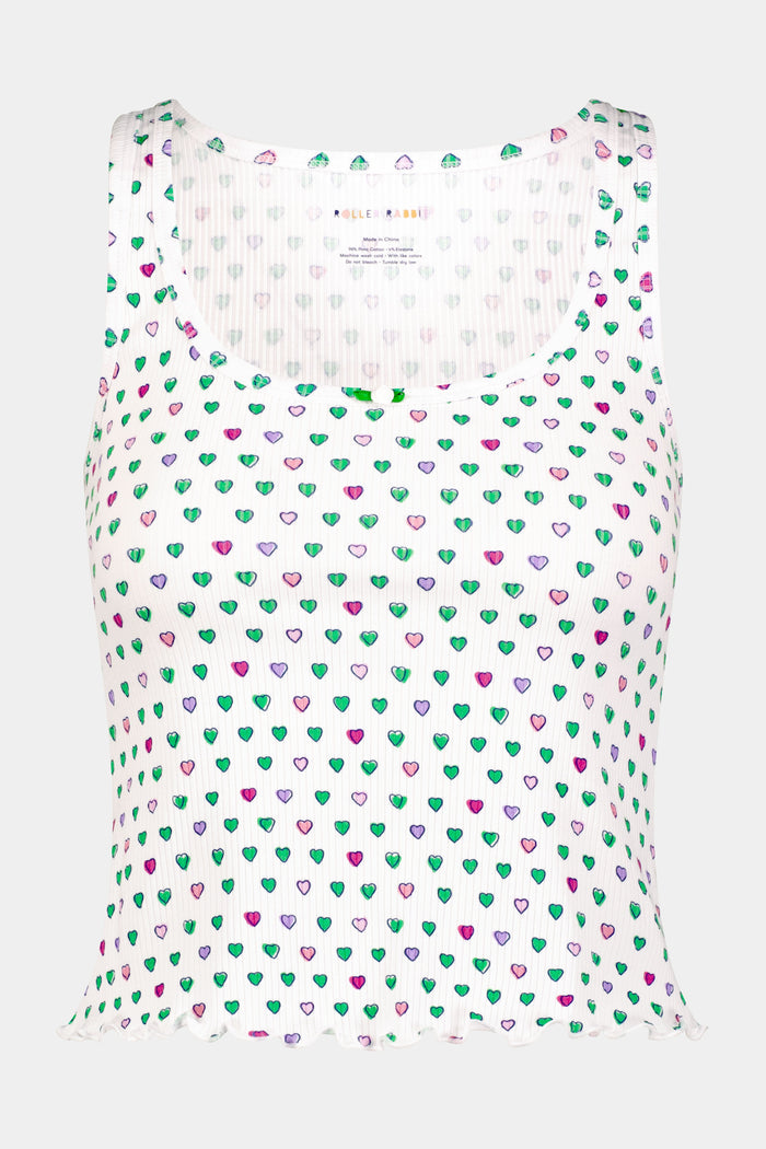 A woman adjusts her Pop Hearts Rib Astor Tank by Roller Rabbit, a sleeveless pajama top with matching shorts, featuring soft pima modal fabric with colorful strawberries on a white background.