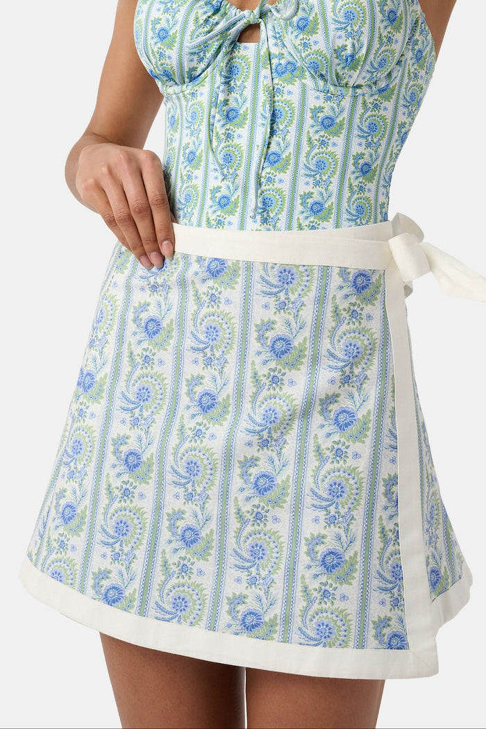 A person wears the Roller Rabbit Provencal Stripe Marisol Wrap Pareo, tying it around their waist. Only their torso and upper legs are visible.