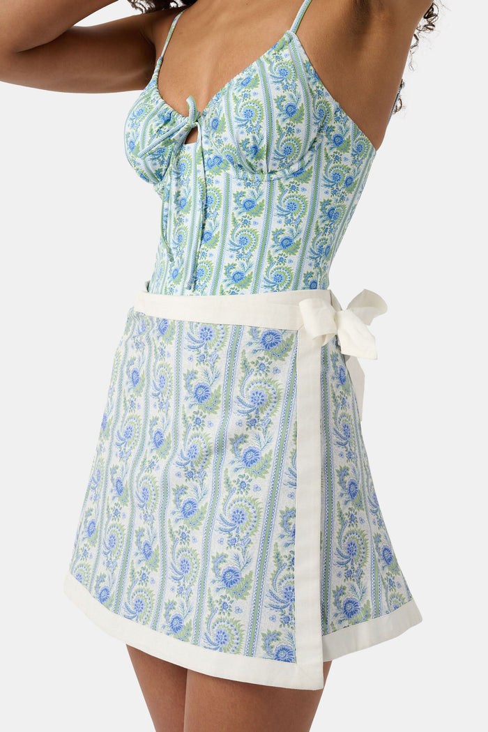 A person wears the Roller Rabbit Provencal Stripe Marisol Wrap Pareo, tying it around their waist. Only their torso and upper legs are visible.