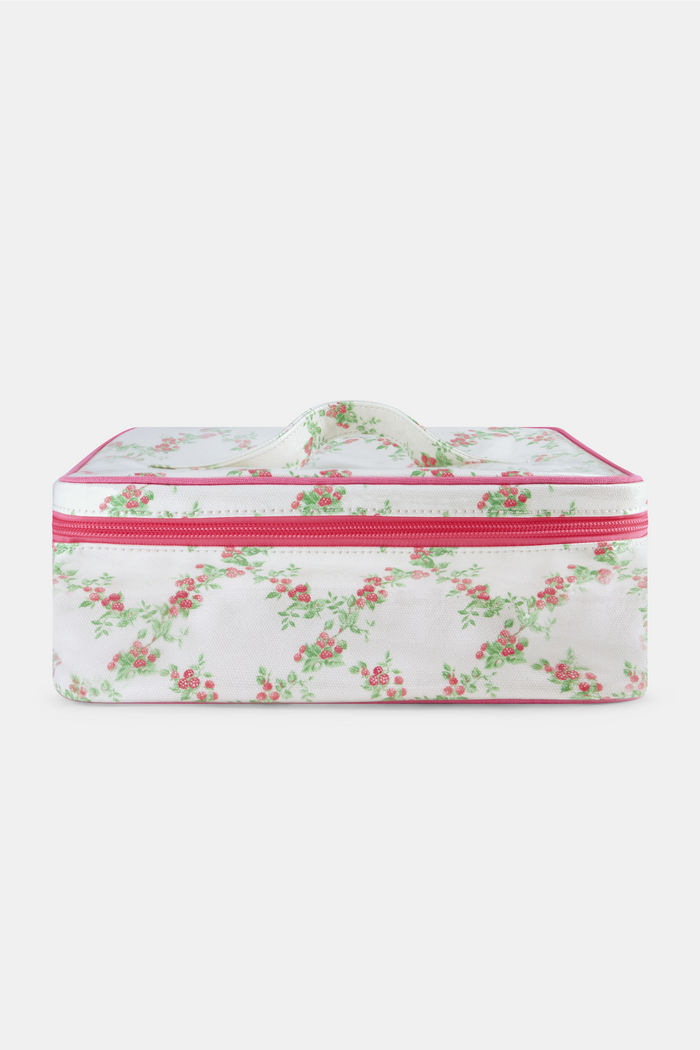 The Roller Rabbit Raspberry Garden Carry All Case is a rectangular cotton canvas bag with a handle, white background, pink floral pattern with green leaves, and a pink zipper.