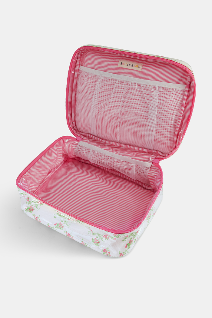 The Roller Rabbit Raspberry Garden Carry All Case is a rectangular cotton canvas bag with a handle, white background, pink floral pattern with green leaves, and a pink zipper.
