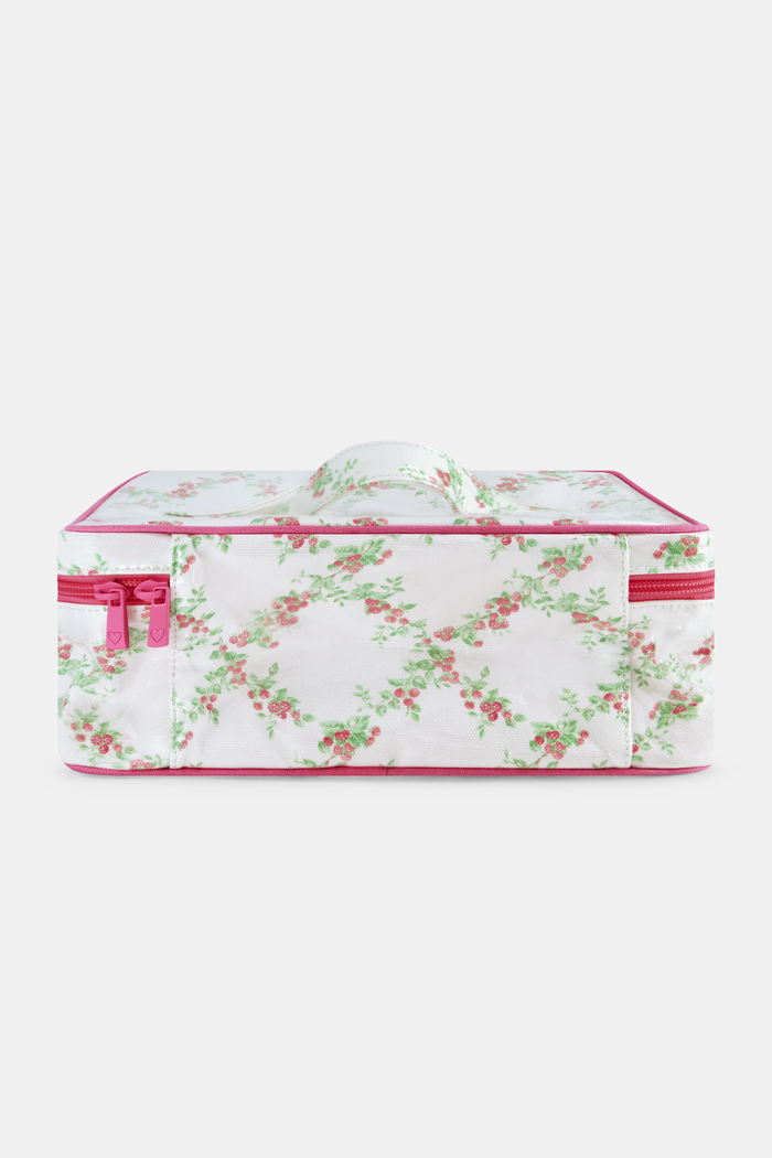 The Roller Rabbit Raspberry Garden Carry All Case is a rectangular cotton canvas bag with a handle, white background, pink floral pattern with green leaves, and a pink zipper.