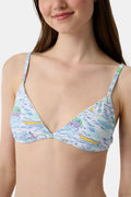 A woman with long brown hair smiles softly, wearing the Regatta Marais Bikini Top by Roller Rabbit in a nautical print, standing against a plain white background.