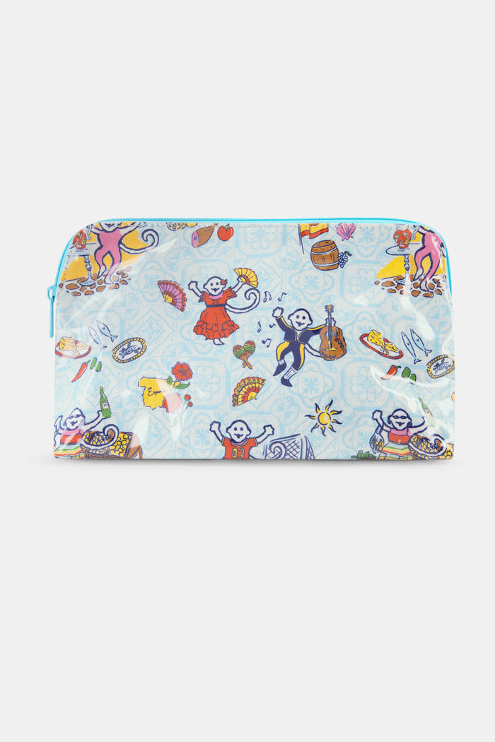 The Spain Monkey Makeup Bag by Roller Rabbit is a colorful cotton canvas pouch featuring playful monkeys in clothes with guitars, fans, fruit, and festive items on a light blue background. Perfect for makeup storage and finished with a blue zipper.