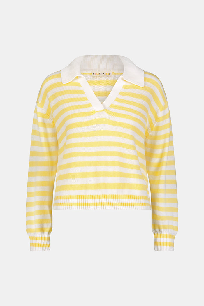 A young woman with light skin and long brown hair wears the Roller Rabbit Striped Rocio Sweater, a pastel yellow, lightweight cotton knit with a wide V-neck and collar. She pairs it with matching drawstring pants and gazes slightly to the side.