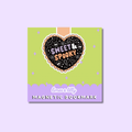 A square product card for a magnetic bookmark featuring a lime green top section, a lavender bottom band, and a central black heart graphic with the words “Sweet & Spooky” in orange and white. The card is centered on a light lavender background.