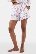 A person stands barefoot in the Roller Rabbit Tinned or Twist Brooklyn Boxer, a white pajama bottom with playful food and drink prints and a comfy elastic waistband. Only the lower half of the body is shown against a plain background.